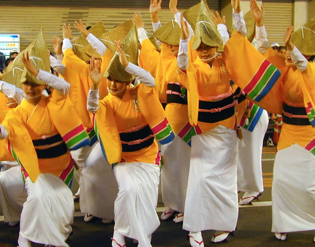 Awa Dance Festival in Tokushima. People dancing in orange shirts and straw hats
